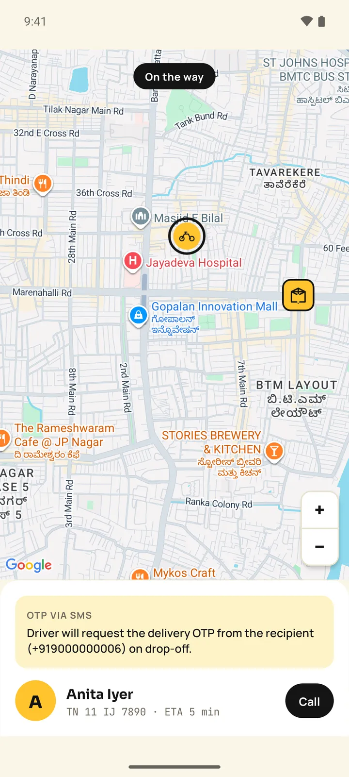Pakka customer app map with an On the way pill, a two-wheeler marker heading to the drop pin, a delivery-code hint and the driver card with ETA